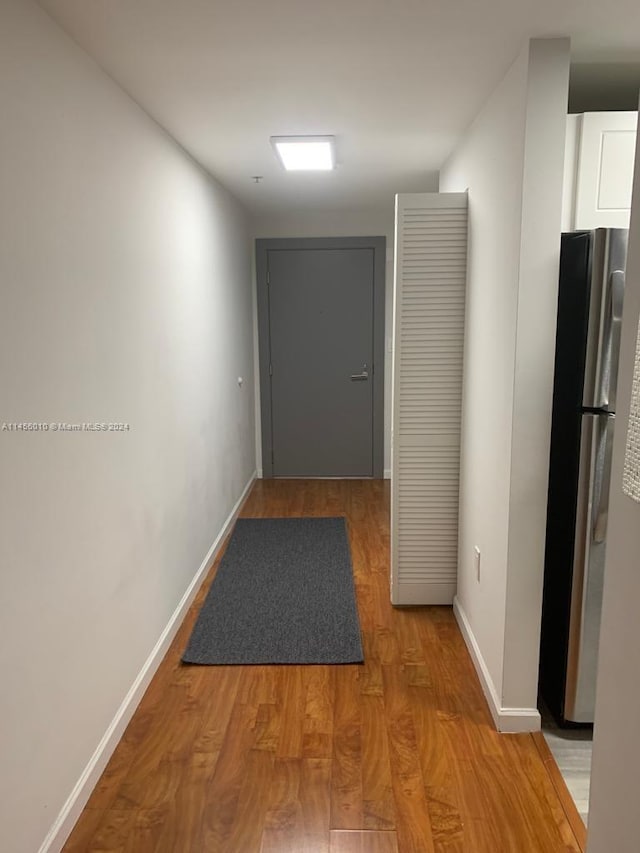 corridor with wood-type flooring