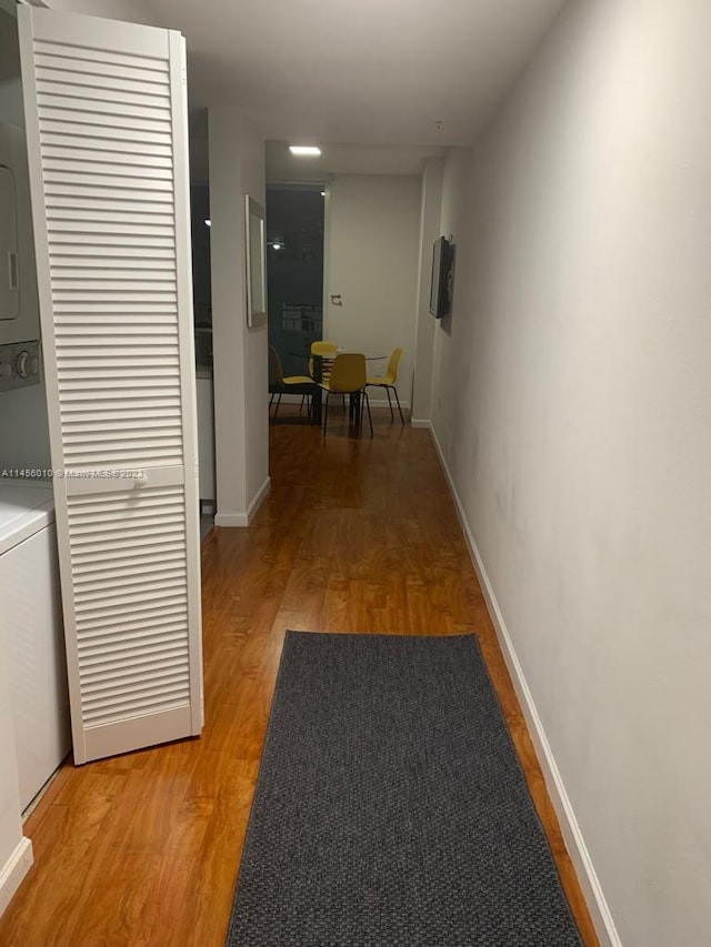 hallway with hardwood / wood-style floors