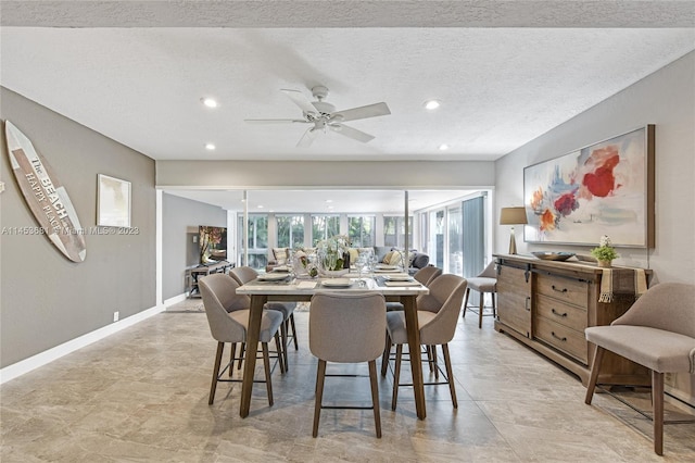 tiled dining space featuring ceiling fan and a textured ceiling