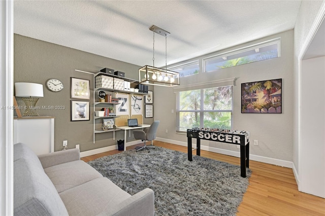 living room featuring a textured ceiling and light hardwood / wood-style floors