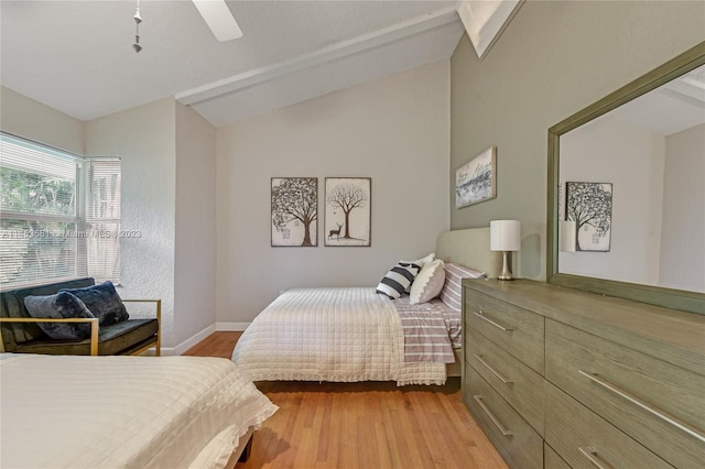 bedroom with lofted ceiling, light hardwood / wood-style floors, and ceiling fan