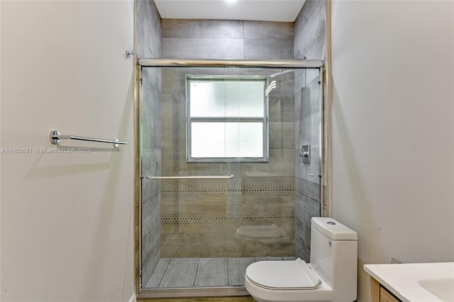 bathroom featuring walk in shower, toilet, and vanity