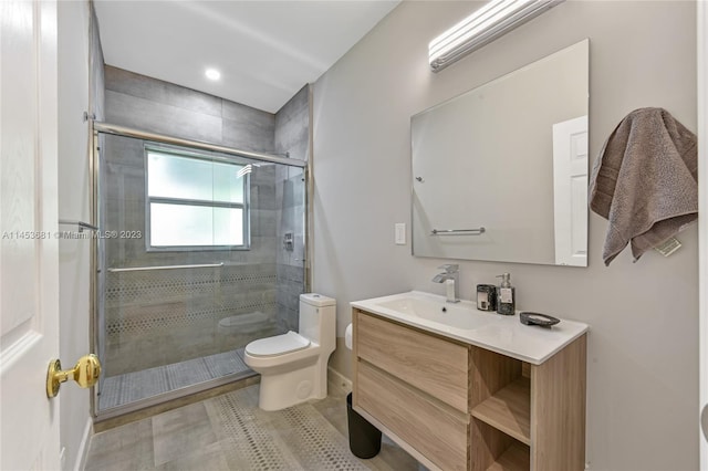 bathroom featuring toilet, large vanity, tile floors, and walk in shower