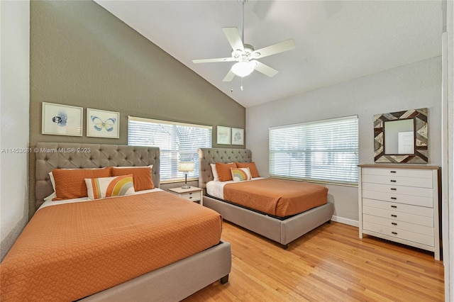 bedroom with high vaulted ceiling, light hardwood / wood-style floors, and ceiling fan