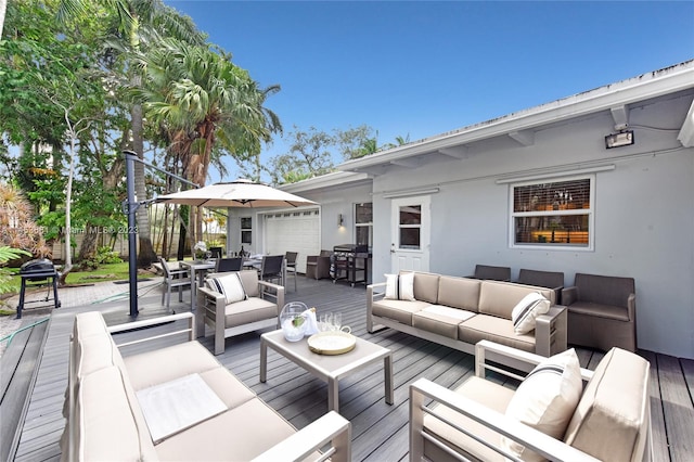 wooden deck featuring an outdoor living space and a garage