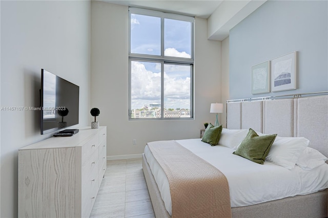 tiled bedroom featuring expansive windows