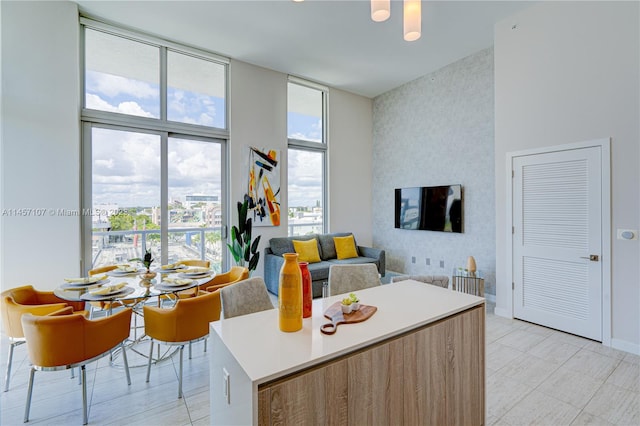 kitchen featuring light tile floors and a wall of windows