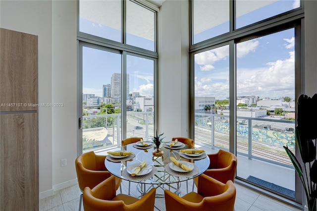 dining space with plenty of natural light and light tile floors