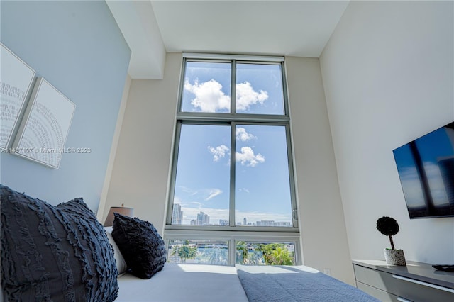 bedroom featuring a towering ceiling