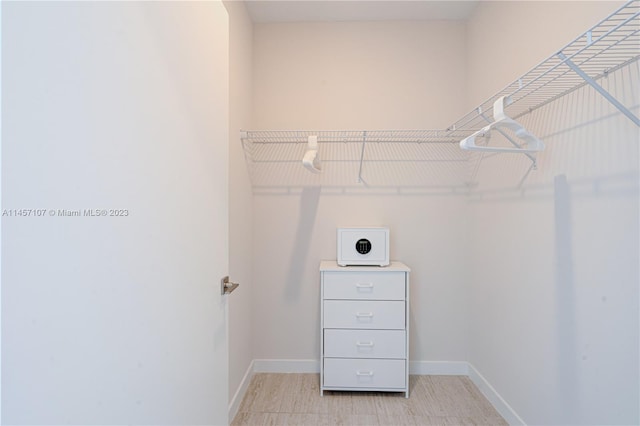 spacious closet featuring light tile flooring