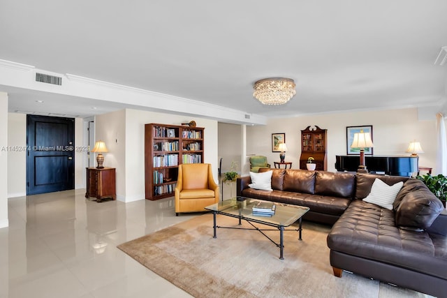 tiled living room with ornamental molding and a chandelier