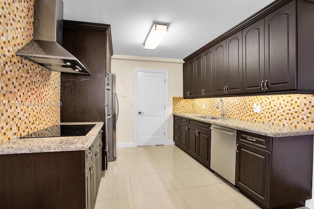 kitchen featuring appliances with stainless steel finishes, light stone counters, wall chimney exhaust hood, and tasteful backsplash