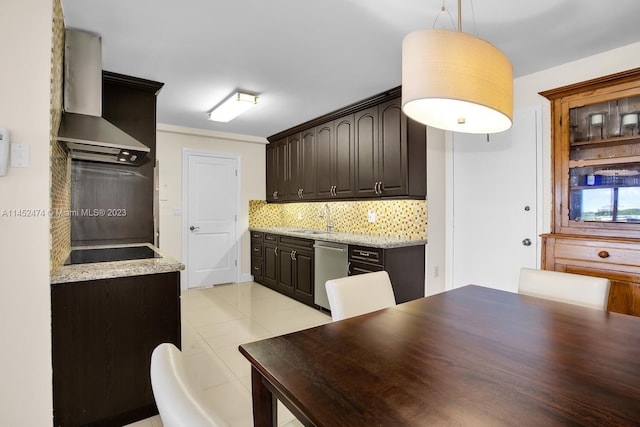 kitchen featuring pendant lighting, stainless steel dishwasher, backsplash, light stone countertops, and wall chimney range hood