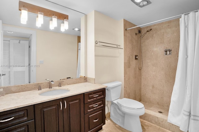 bathroom featuring a shower with curtain, toilet, and large vanity