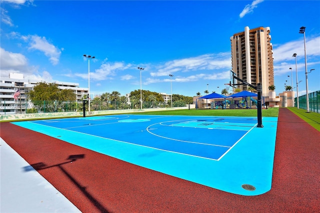 view of basketball court featuring a playground