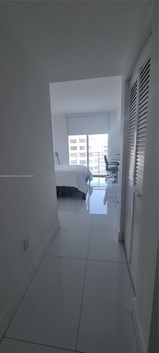 hallway featuring light tile floors