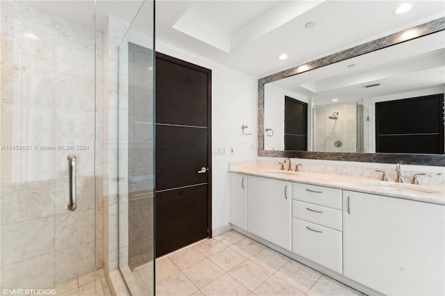 bathroom featuring tile patterned flooring, a shower with shower door, a raised ceiling, and vanity