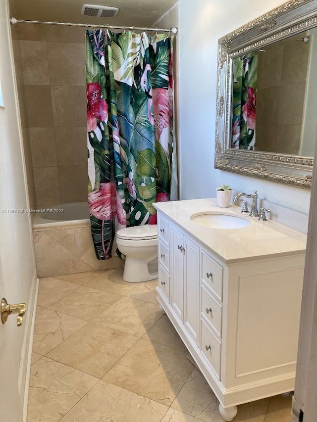 bathroom with vanity, tile floors, and toilet