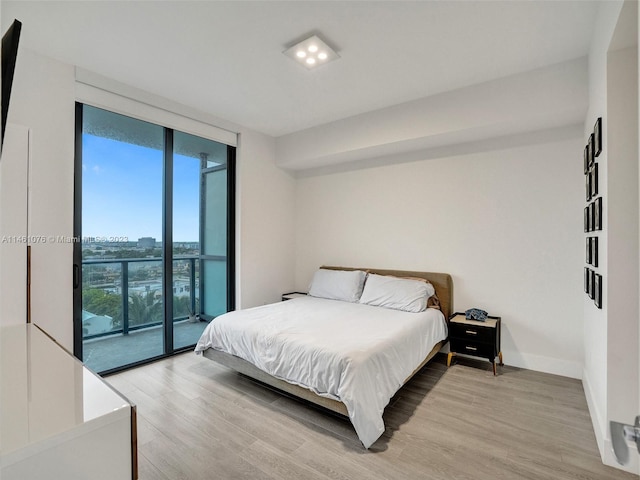 bedroom with access to outside and light hardwood / wood-style flooring