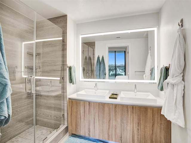 bathroom with an enclosed shower and double vanity