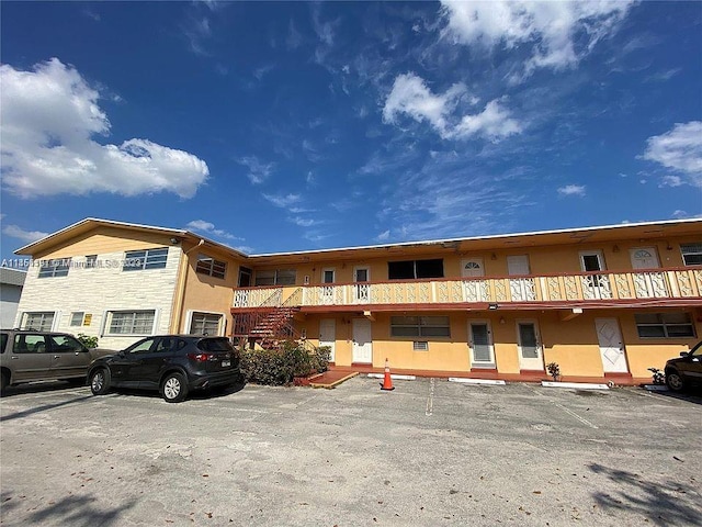 view of building exterior featuring uncovered parking