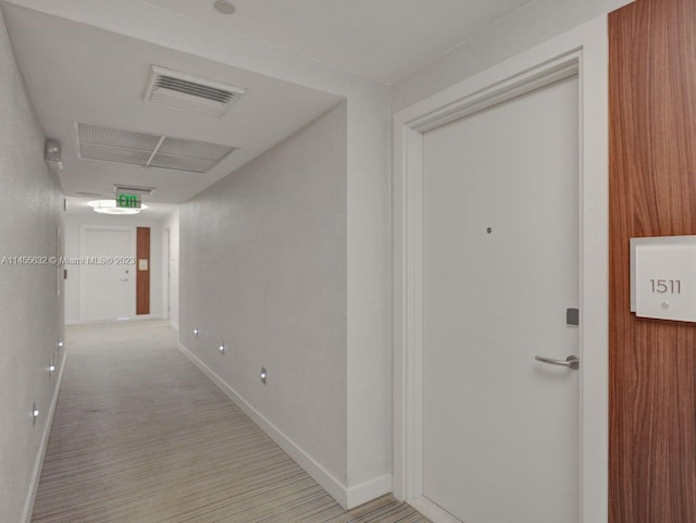 corridor with light colored carpet