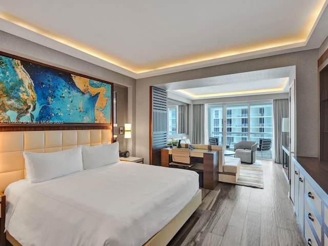 bedroom featuring a raised ceiling and hardwood / wood-style floors