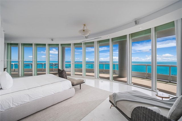 bedroom featuring a water view, a view of the beach, access to outside, and a wall of windows