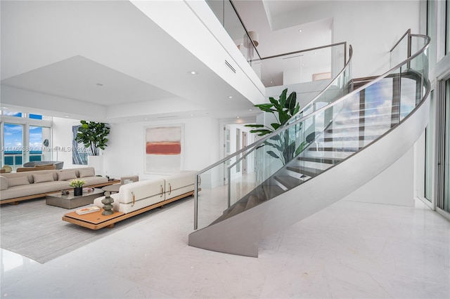 living room featuring a towering ceiling