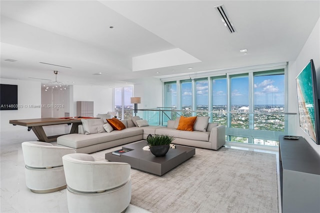 living room featuring an inviting chandelier and floor to ceiling windows