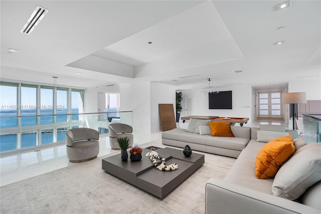 living room with plenty of natural light and a water view