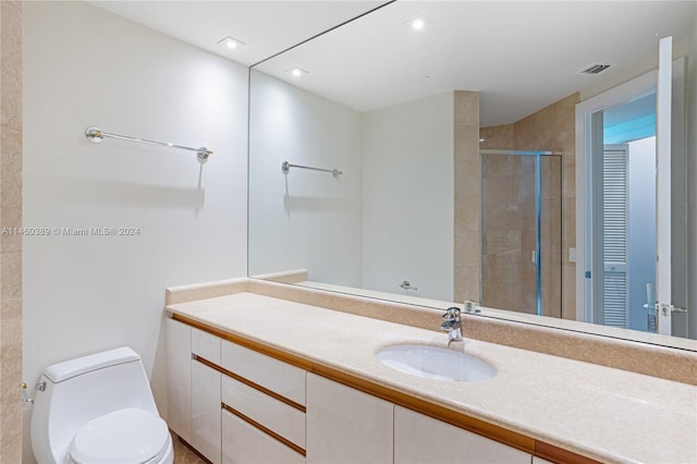 bathroom featuring vanity, toilet, and an enclosed shower