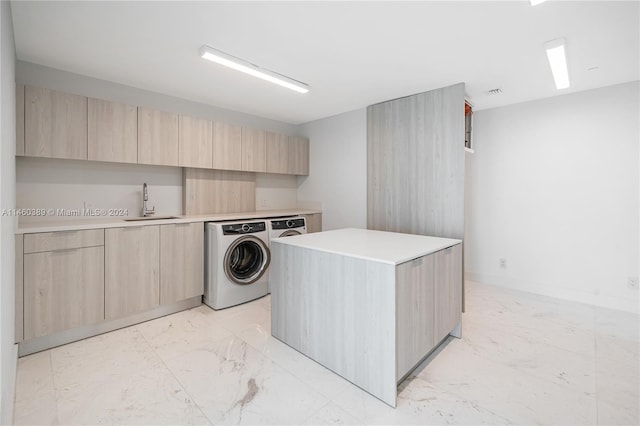 laundry room featuring sink and washer and clothes dryer