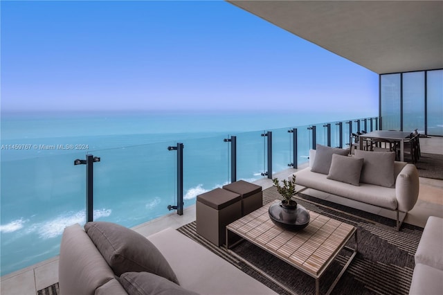 balcony with outdoor lounge area and a water view