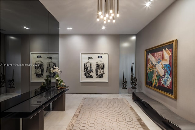 hall featuring an inviting chandelier and light tile floors