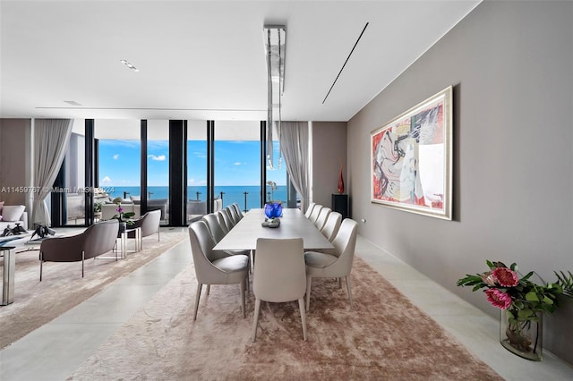 dining space featuring a water view and floor to ceiling windows