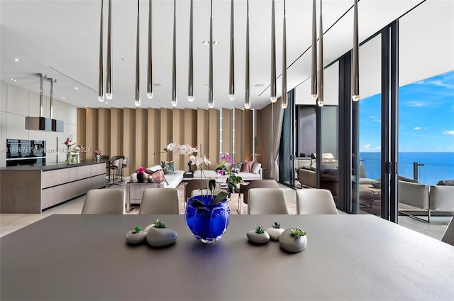 tiled dining space with floor to ceiling windows and a water view