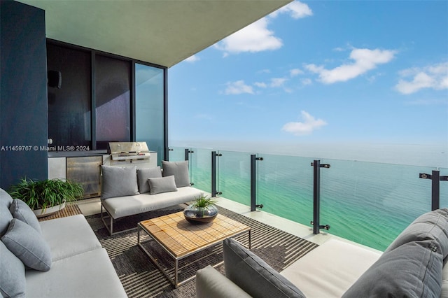 balcony featuring a water view, an outdoor hangout area, and grilling area