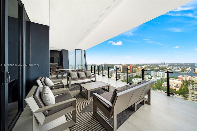 balcony featuring a water view and an outdoor living space