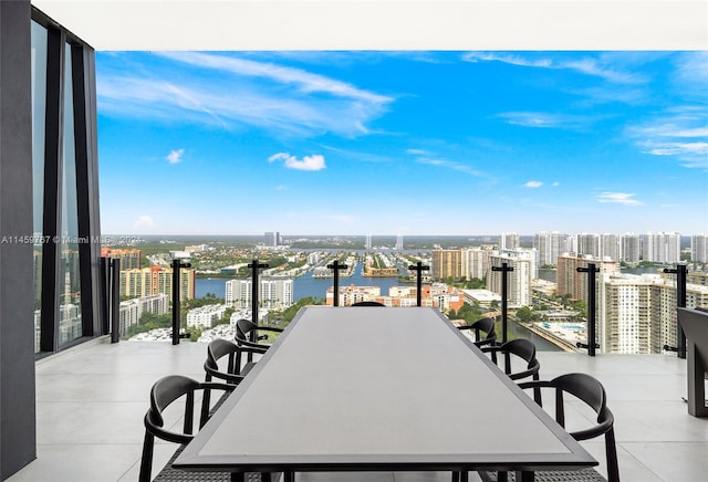 view of terrace with a balcony and a water view