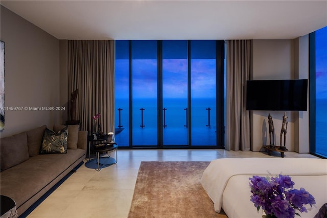 tiled living room featuring a water view