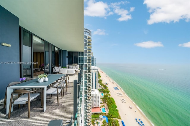 balcony with a water view and a beach view