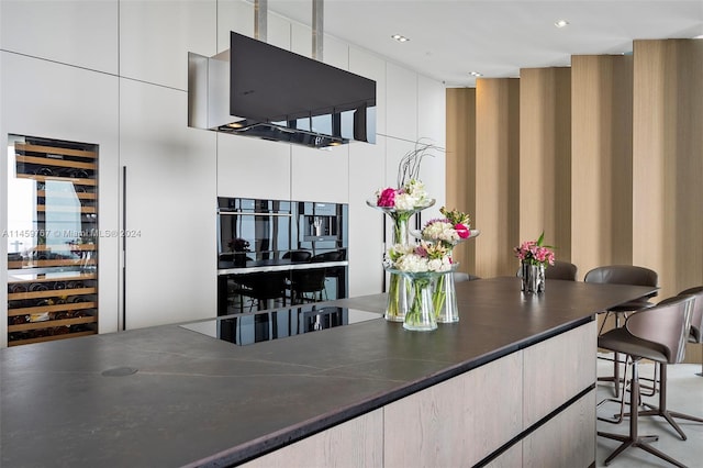 bar with oven, white cabinetry, and black electric stovetop