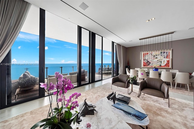 living room featuring floor to ceiling windows and a water view