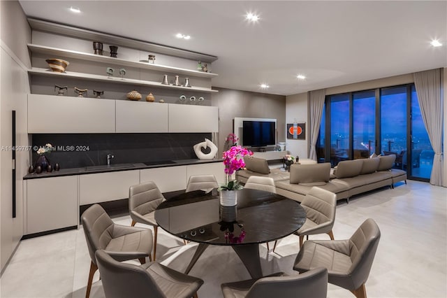 dining space with light tile floors and sink