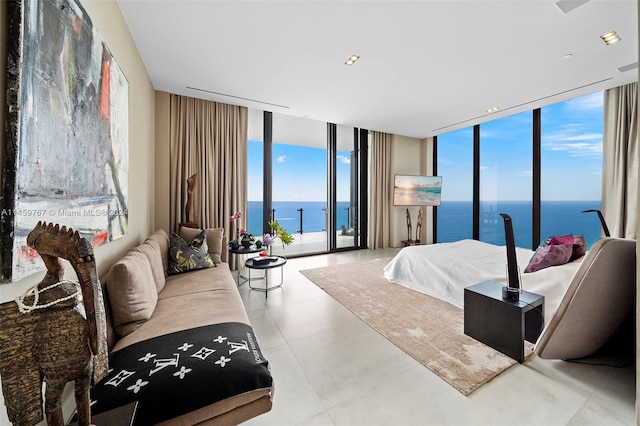 bedroom with light tile flooring, a wall of windows, access to outside, and a water view