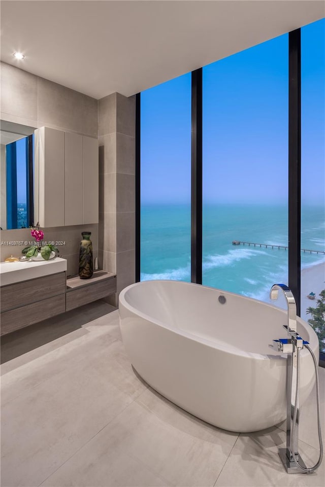 bathroom featuring a water view, tile flooring, and vanity