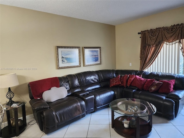 tiled living room featuring a textured ceiling