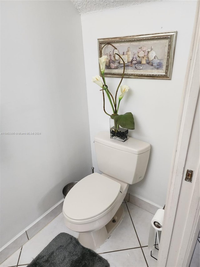 bathroom with toilet and tile patterned flooring