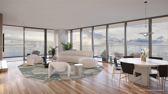 living room with a water view, a wealth of natural light, and light wood-type flooring